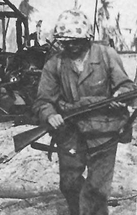Soldier carrying a 1897 pump action shotgun