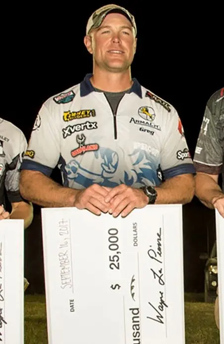 Greg Jordan posing with twentyfive thousand dollar check