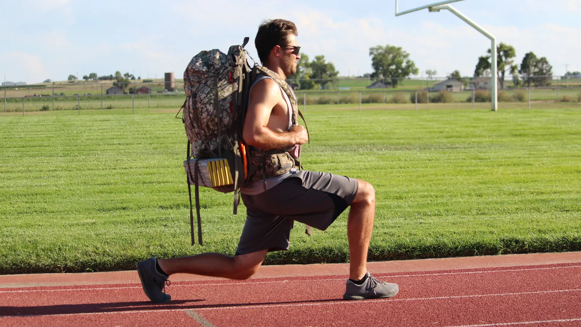 Man doing lunges on a track