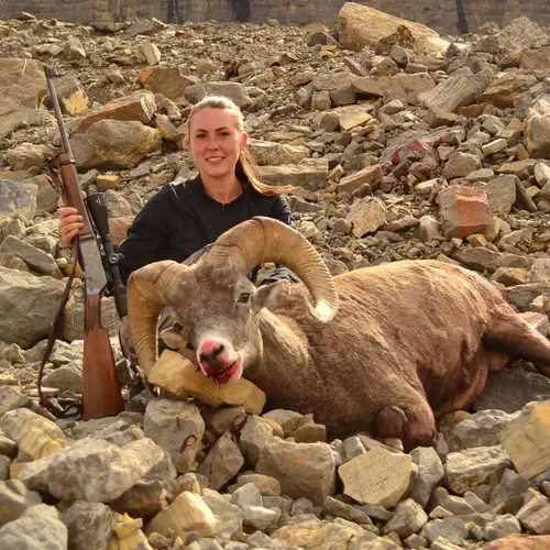Female hunter hero shot with Big Horn Sheep and BLR lever action rifle