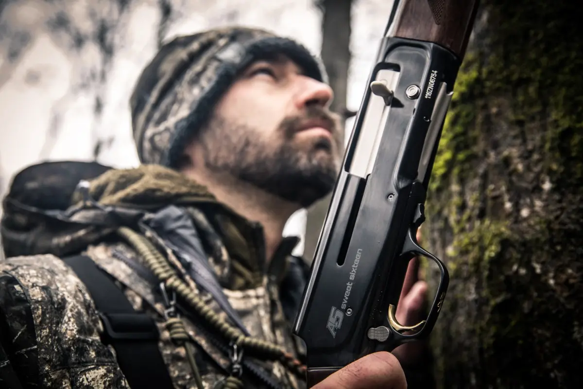 Duck hunter in timber with A5 Sweet 16 semi-auto shotgun.