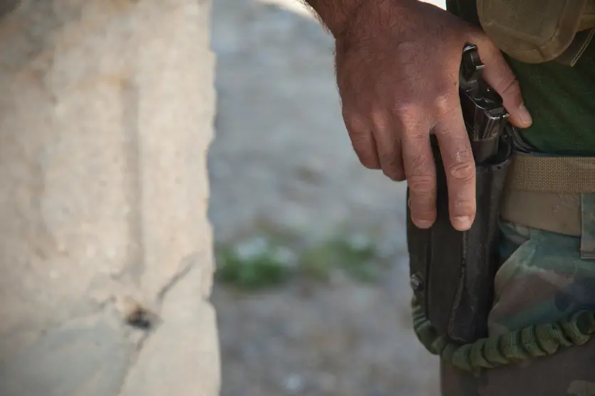 A custom 1911 rides along on a Marine’s duty belt.