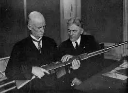 John M. Browning personally evaluates the quality of a military BAR produced by Winchester.