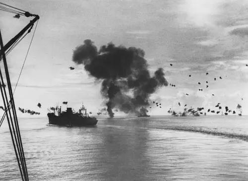 Battleship with shots fired all around it