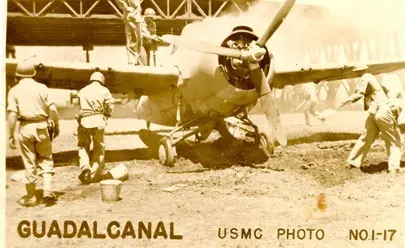 Marines rally to put out the flames on an F4F Wildcat hit by enemy fire