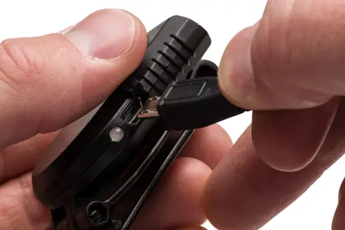 Plugging USB cord into Night Seeker rechargeable flashlight.