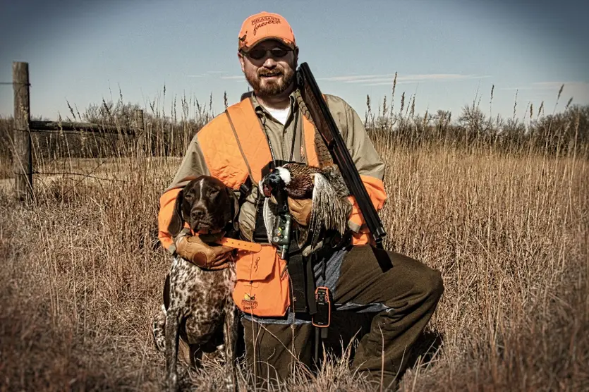 Bob St. Pierre with dog and pheasant