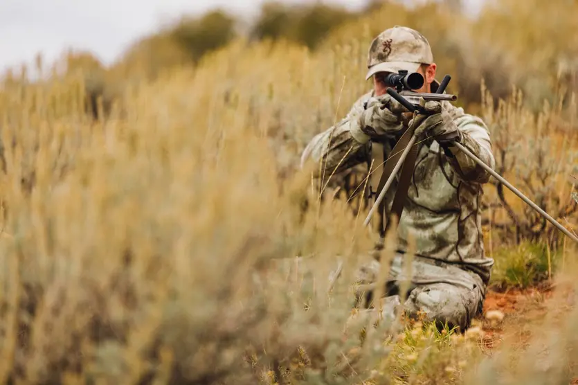Hunter in Herofit clothing setup on shooting sticks with X-Bolt rifle.