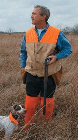 George W. Bush upland bird hunting with over and under shotgun.