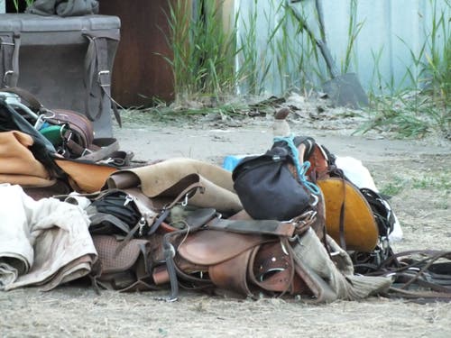 Unbranded saddles on the ground.