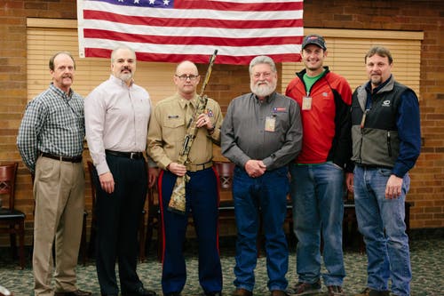 Group photo of presentation of shotgun to Veteran.
