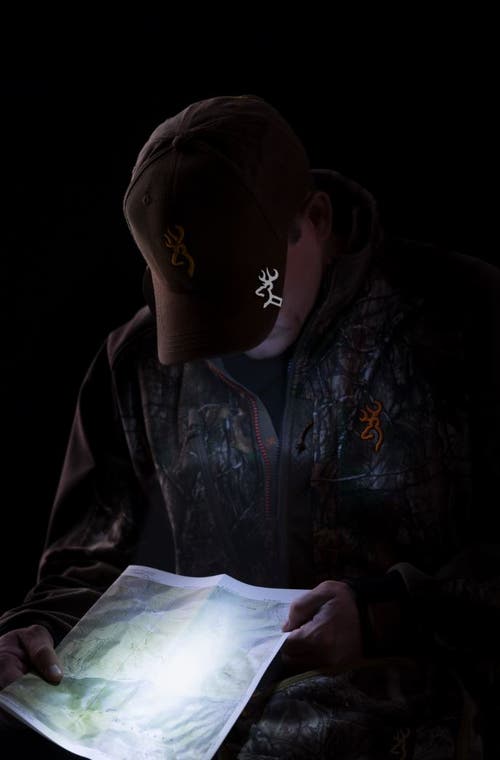 Hunter reading map with cap light.
