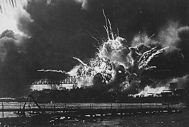 The USS Shaw erupts in a massive fireball during the attack on Pearl Harbor.