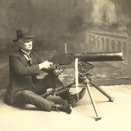 John M. Browning with machine gun.
