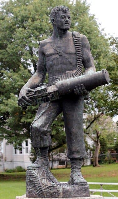 A bronze statue of GySgt John Basilone, still cradling his Browning water-cooled machine gun stands in hometown of Raritan, New Jersey.