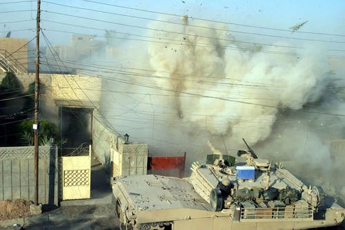 A Marine M1 Abrams tank puts the hammer down in Fallujah, Iraq