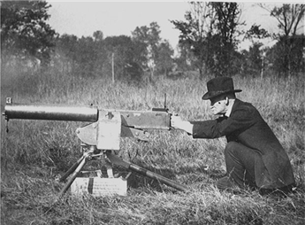 John M. Browning personally tests an early prototype of his .50 caliber water-cooled machine gun in 1918 near the close of WWI.