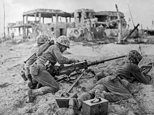 This three-man Marine machine gun team readies their .50 caliber Browning M2HB for action soon after the Inchon landing.