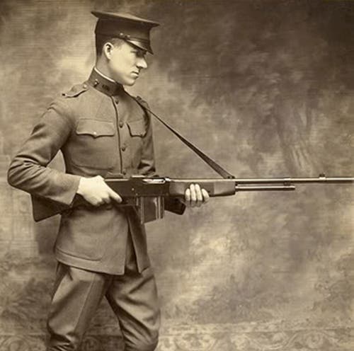 Lt. Val Browning demonstrates firing a Browning Automatic Rifle (BAR) from the hip.