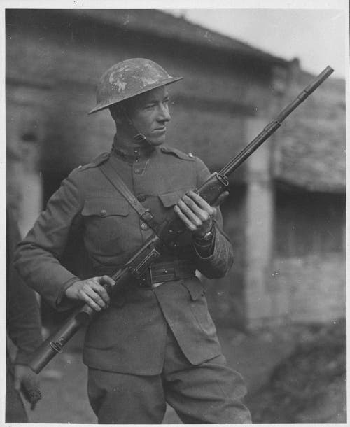 Val Browning holding BAR machine gun