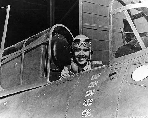 Navy LT Edward “Butch” O’Hare smiling from airplane cockpit.