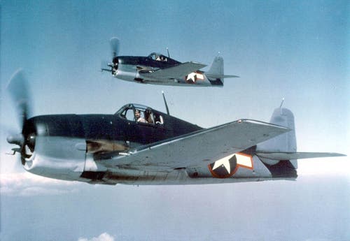 A pair of Grumman F6F-3 Hellcats of the US Navy aloft above the Pacific during WWII. 