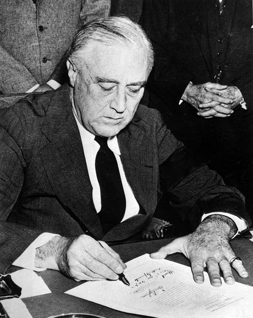 FDR signs the formal declaration of war against the Empire of Japan on December 8, 1941. 