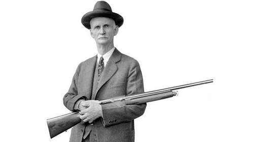 John M. Browning holding an Auto-5 semi-auto shotgun.