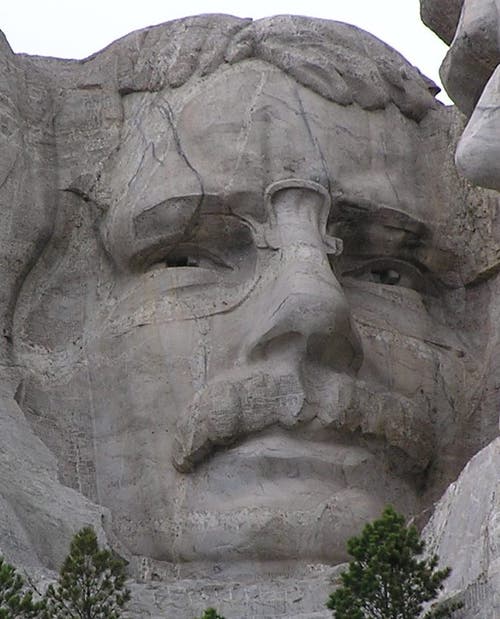 Theodore Roosevelt appears along side of Washington, Jefferson and Lincoln on Mt. Rushmore.