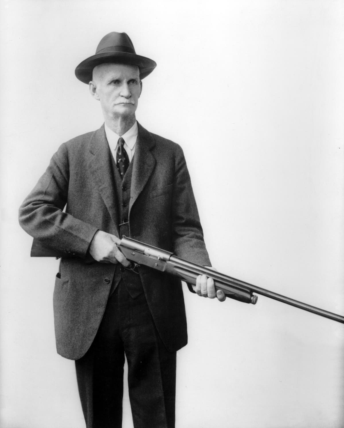John Moses Browning holding his Automatic 5 shotgun