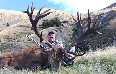 Brett Flaugher with giant New Zealand stag from about 200 yds. 