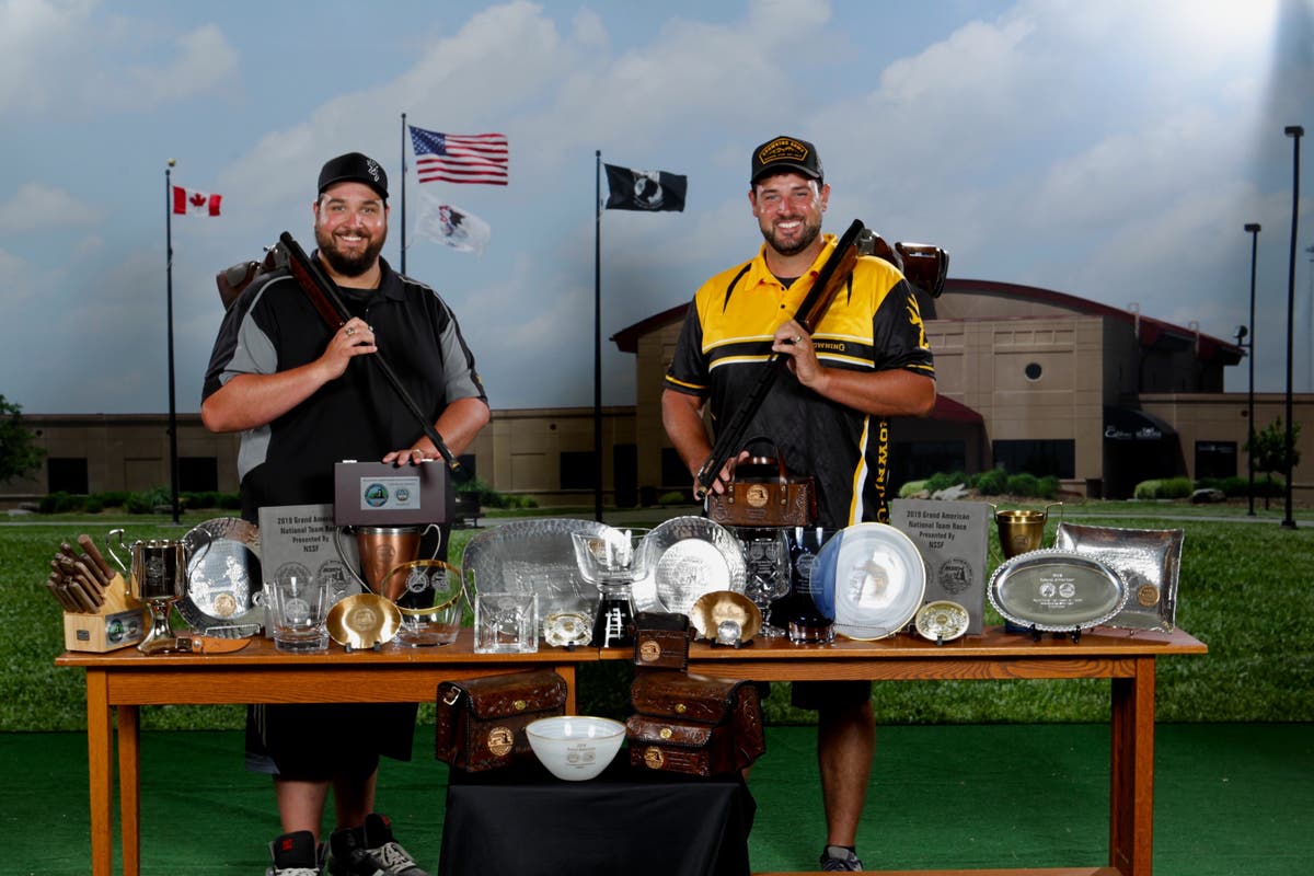 Matt and Foster Bartholow with Citori shotguns and trophies from the 2019 Grand American