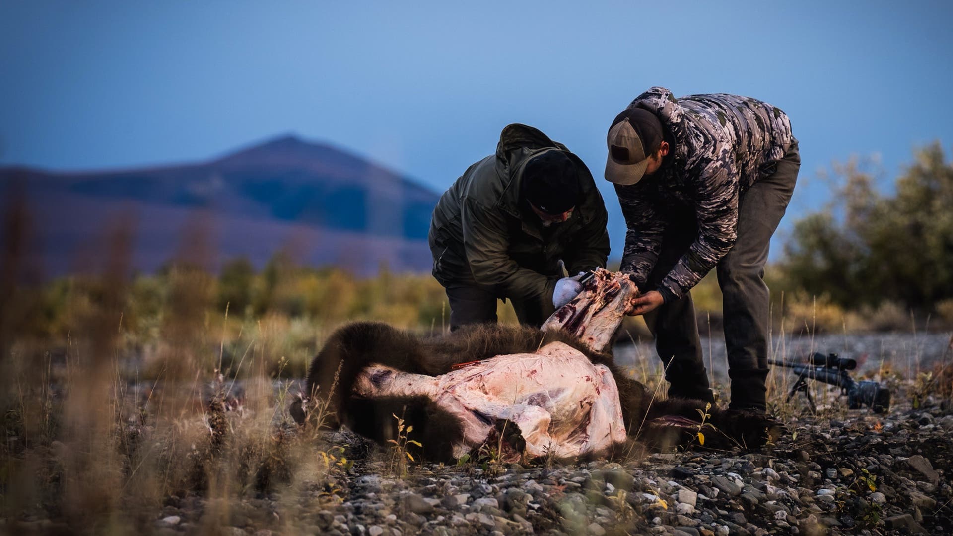 Hunters skinning a bear