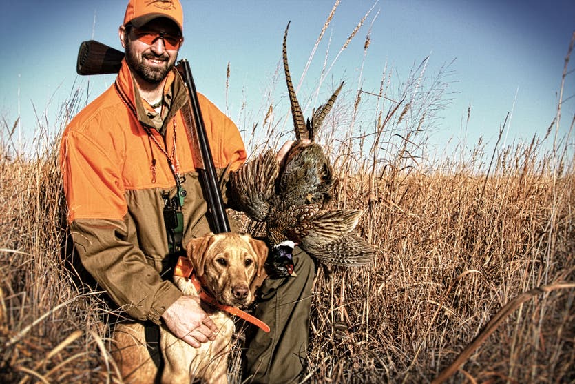 Andrew Vavra with dog and pheasant.