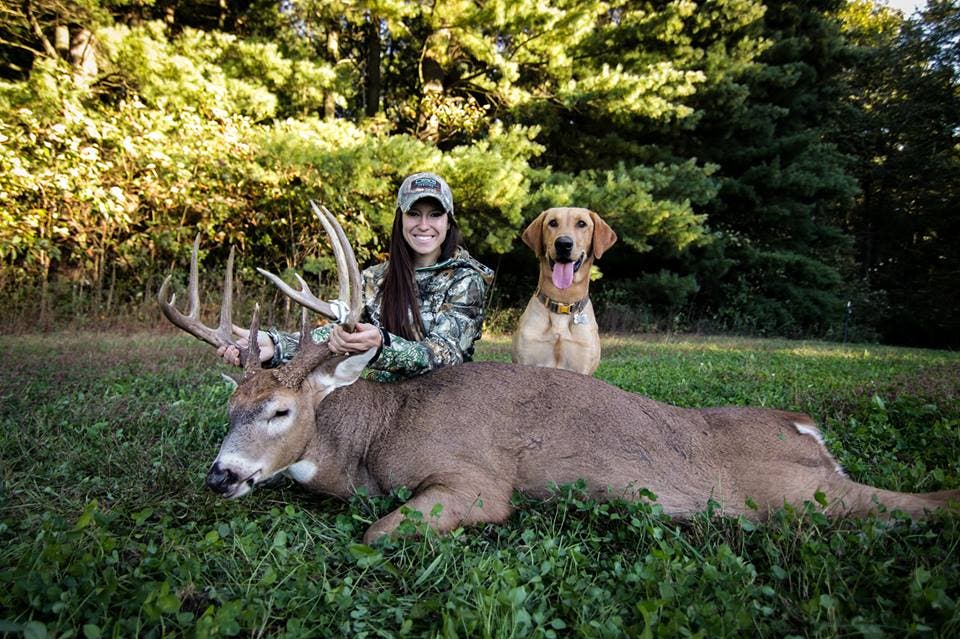 Brittany Jill with whitetail and dog