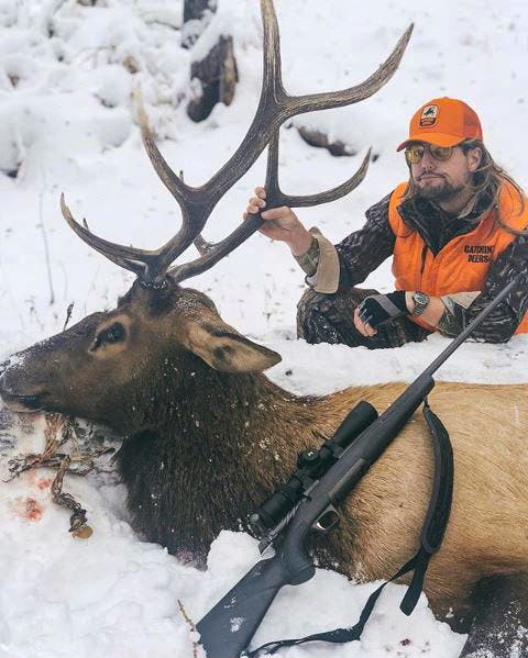 Rut Daniels with elk and rifle