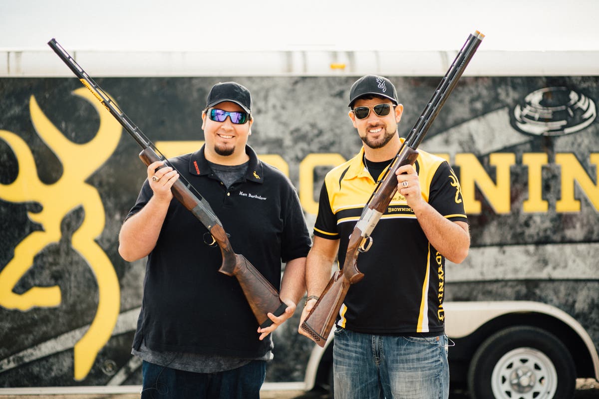 Matt and Foster posing in front of Browning trailer with shotguns