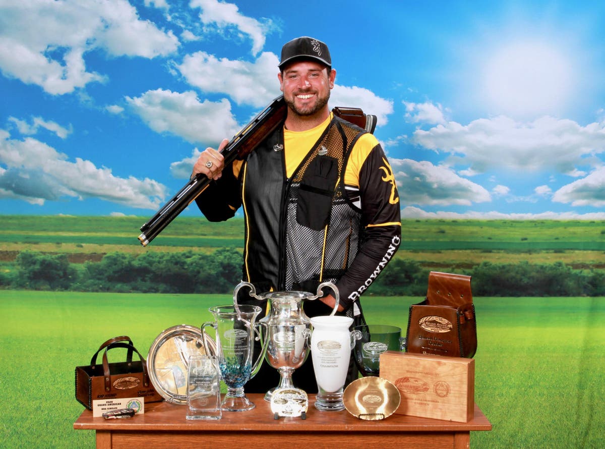 Foster Bartholow posing with his Citori shotgun and trophies from the 2020 Grand American