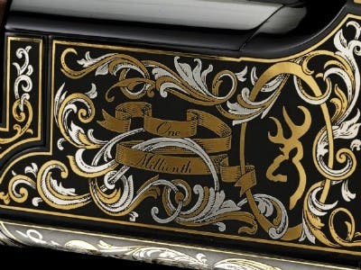 Silver and gold highlighted engraving on Citori shotgun.