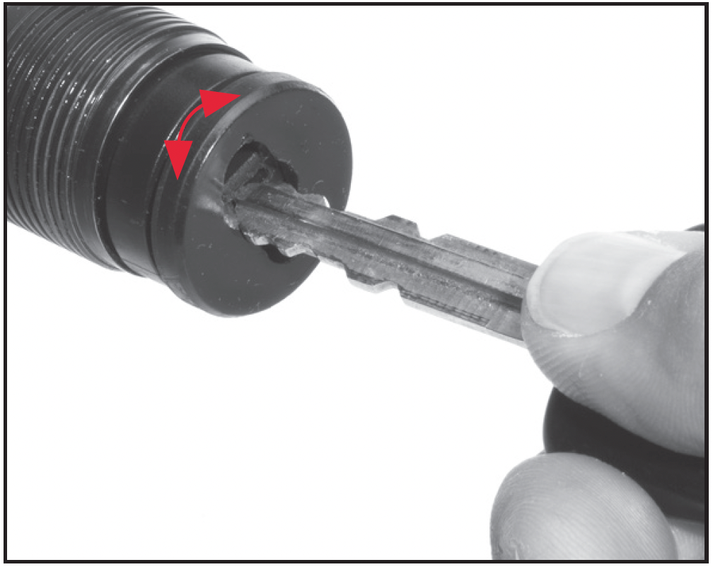 Use a key or small screwdriver to press in  on the three-shot adaptor (plug), then rotate a quarter-turn.