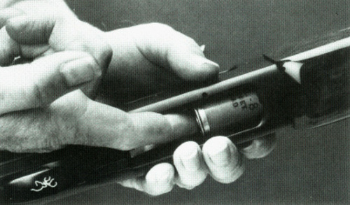 Figure 14. Depressing the cartridge stop.