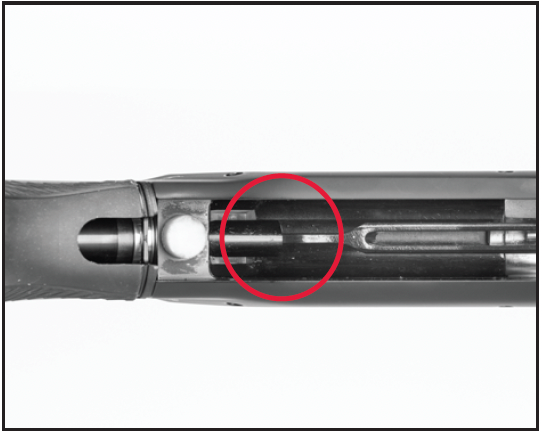 Guide the bolt slide link into its socket in the recoil spring follower.