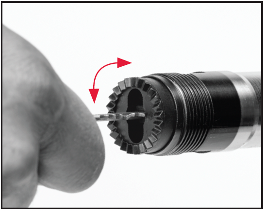 Use a key or small screwdriver to press in  on the three-shot adaptor (plug), then rotate a quarter-turn.