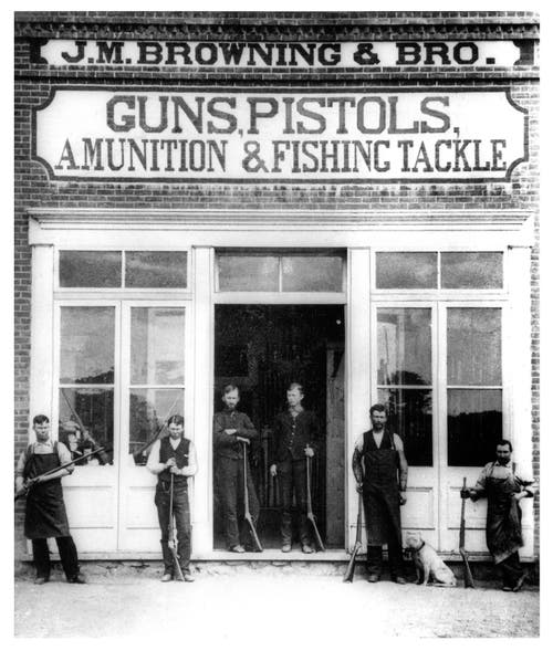 The Browning Brothers Store in Ogden, Utah. John Browning and his crew, several holding his Single Shot Rifle. 